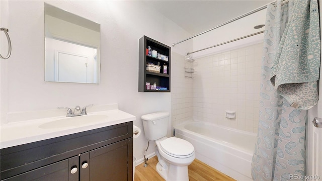 full bathroom with vanity, toilet, wood finished floors, and shower / tub combo