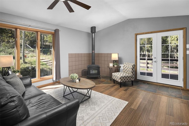 32252 Steven Way, Conifer, CO 80433 - living room with french doors, vaulted ceiling, a ceiling fan, a wood stove, and wood finished floors