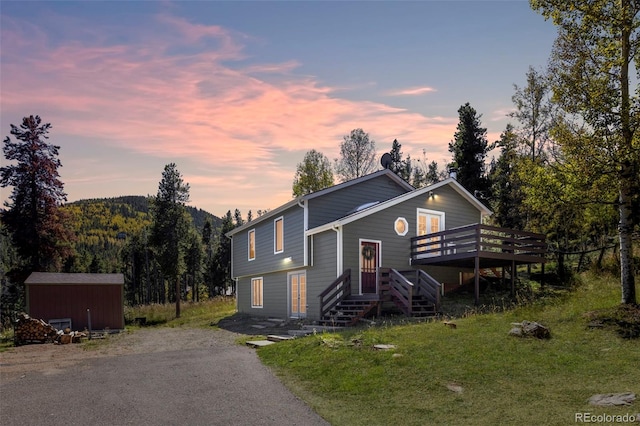 32252 Steven Way, Conifer, CO 80433 - view of front of home with a wooden deck and a shed