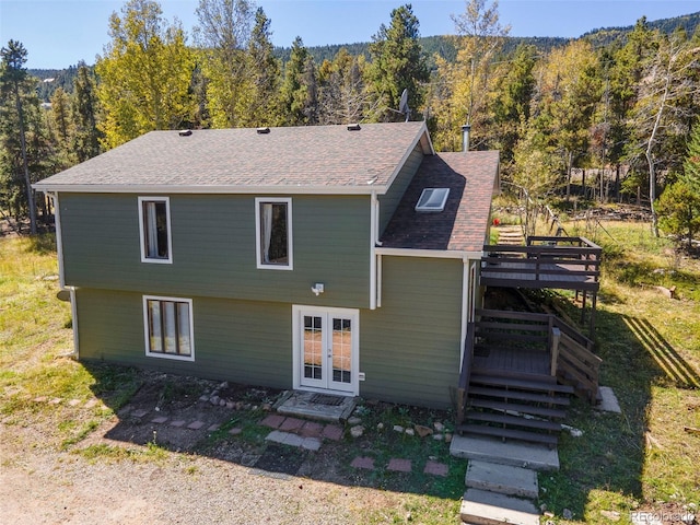 32252 Steven Way, Conifer, CO 80433 - back of house featuring french doors, a wooded view, a wooden deck, roof with shingles, and stairs
