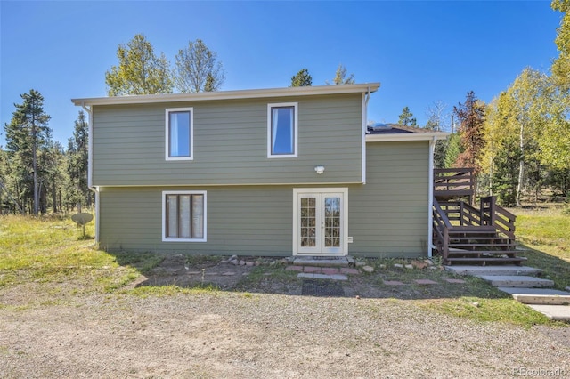 32252 Steven Way, Conifer, CO 80433 - back of property with french doors, stairs, and a wooden deck