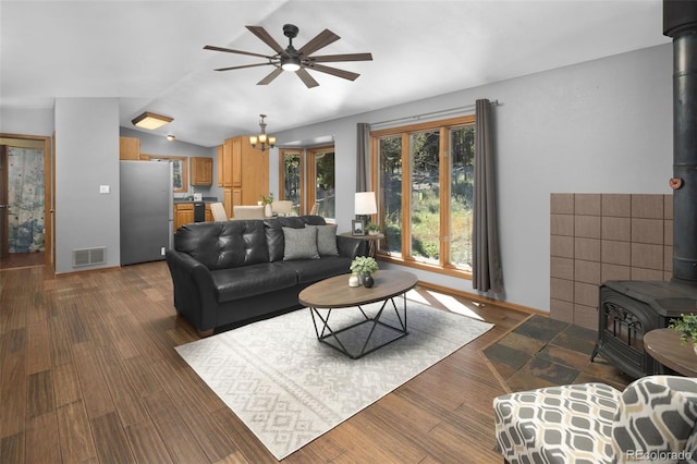 32252 Steven Way, Conifer, CO 80433 - living area with a wood stove, ceiling fan, vaulted ceiling, a chandelier, and wood finished floors