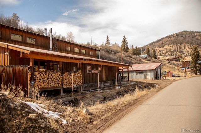 view of front facade with a mountain view and board and batten siding