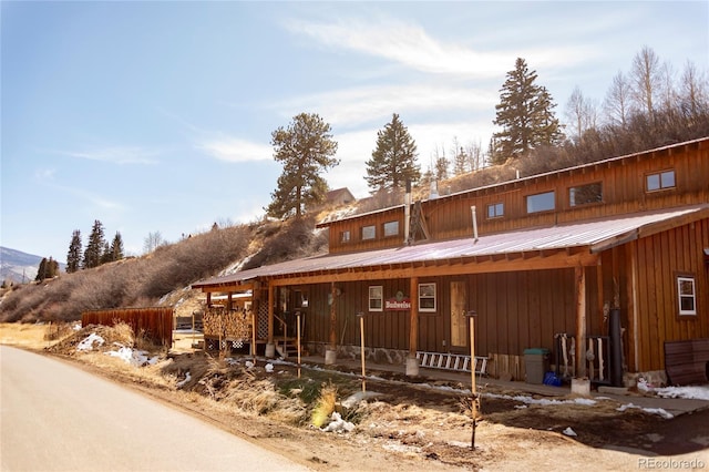 view of front of home with board and batten siding and metal roof