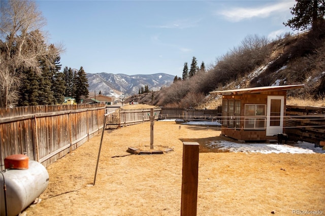 view of yard featuring a fenced backyard and a mountain view