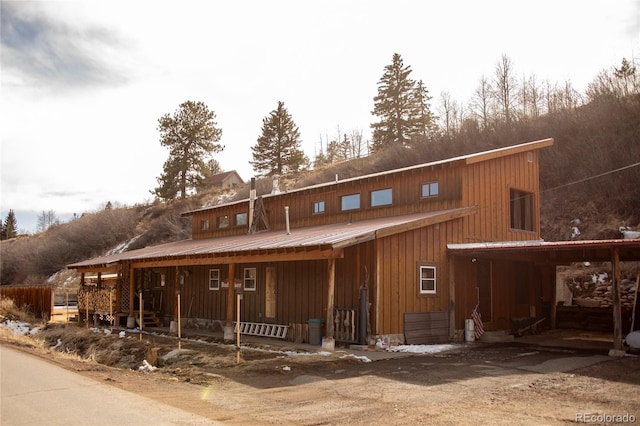 view of front of house featuring a porch and metal roof