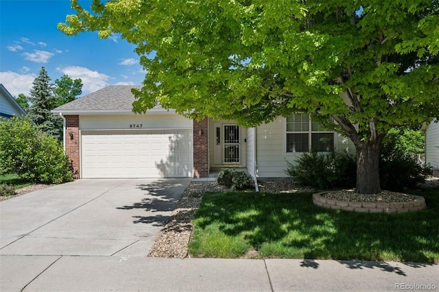 9747 W Peakview Dr, Littleton, CO 80123 - obstructed view of property featuring an attached garage, concrete driveway, brick siding, and a front yard