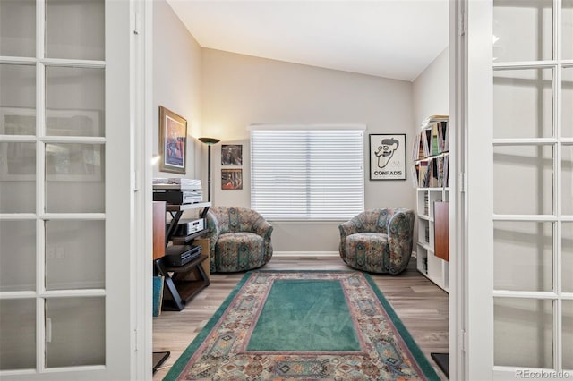 9747 W Peakview Dr, Littleton, CO 80123 - sitting room featuring wood finished floors, french doors, and lofted ceiling