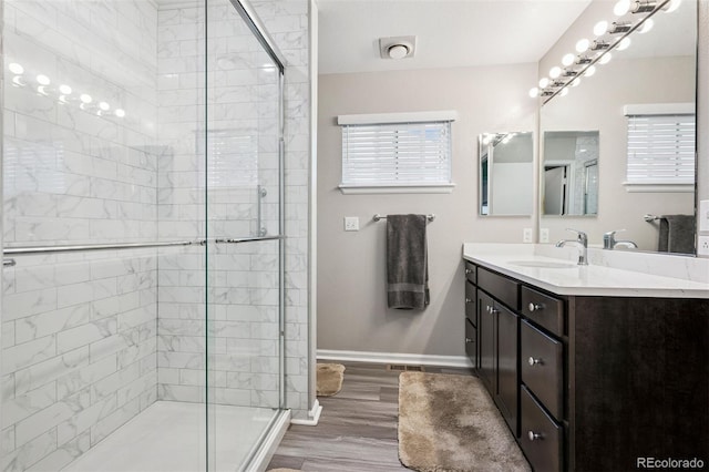 9747 W Peakview Dr, Littleton, CO 80123 - bathroom with vanity, a stall shower, and wood finished floors