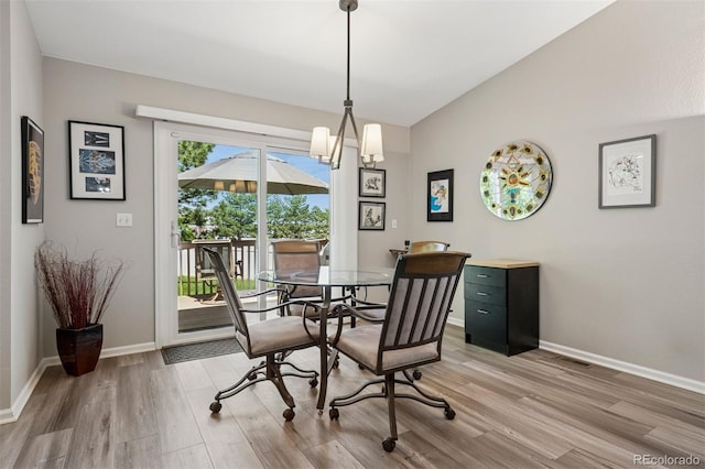 9747 W Peakview Dr, Littleton, CO 80123 - dining room with light wood-style flooring, lofted ceiling, and a chandelier