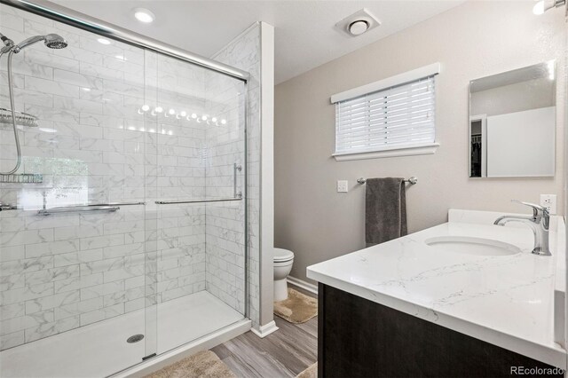 9747 W Peakview Dr, Littleton, CO 80123 - bathroom featuring vanity, a stall shower, and wood finished floors
