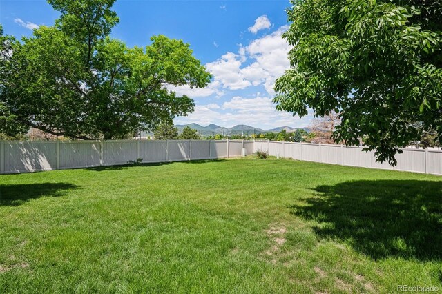 9747 W Peakview Dr, Littleton, CO 80123 - fenced backyard featuring a mountain view
