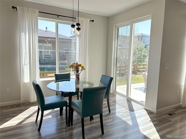 9482 Kendrick Way, Arvada, CO 80007 - dining space featuring healthy amount of natural light, wood finished floors, and baseboards