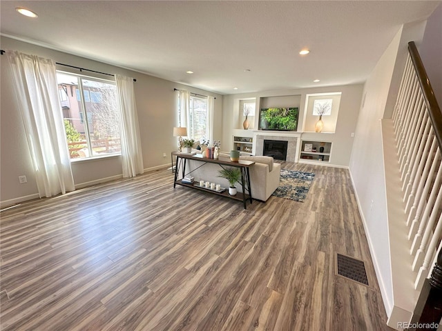 9482 Kendrick Way, Arvada, CO 80007 - living room with wood finished floors, recessed lighting, baseboards, and a tiled fireplace