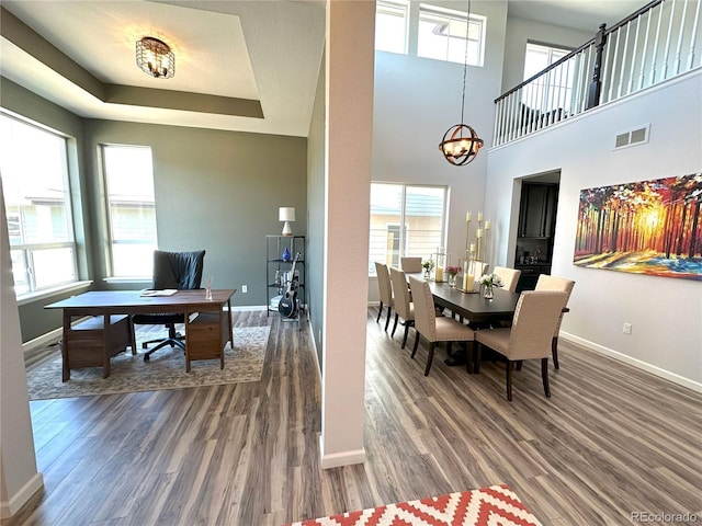 9482 Kendrick Way, Arvada, CO 80007 - dining space with wood finished floors, plenty of natural light, baseboards, and a chandelier