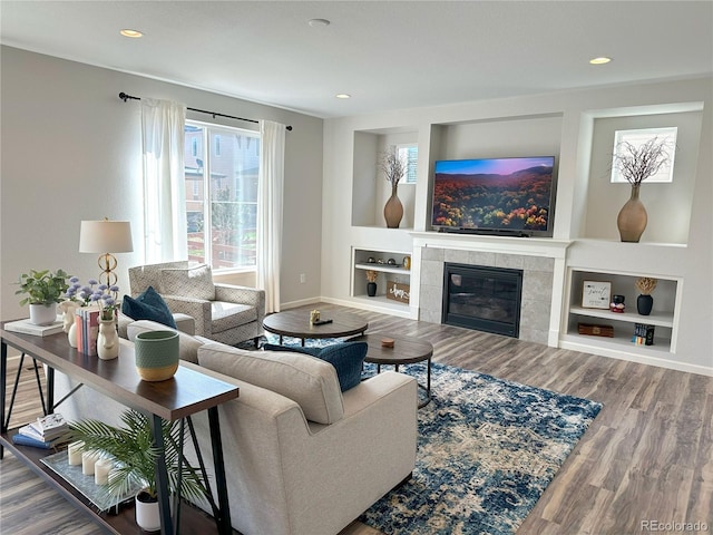 9482 Kendrick Way, Arvada, CO 80007 - living area with built in features, a fireplace, wood finished floors, and recessed lighting