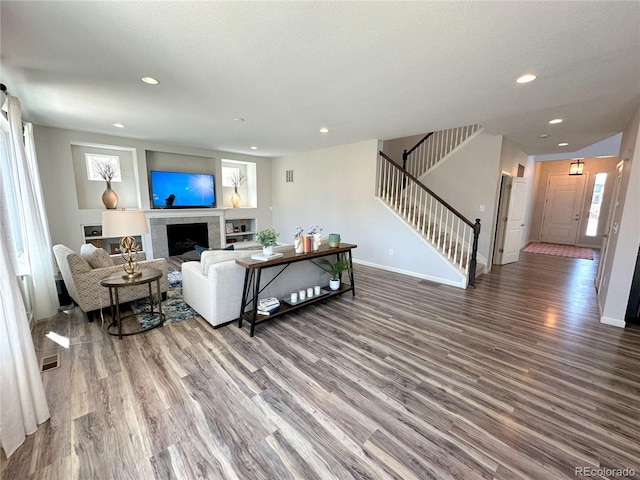9482 Kendrick Way, Arvada, CO 80007 - living room with wood finished floors, stairs, recessed lighting, and a fireplace