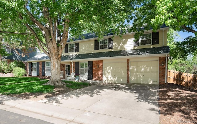 6624 S Sycamore St, Littleton, CO 80120 - view of front of property featuring brick siding, driveway, and an attached garage