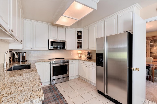 6624 S Sycamore St, Littleton, CO 80120 - kitchen with appliances with stainless steel finishes, a sink, tasteful backsplash, and white cabinets