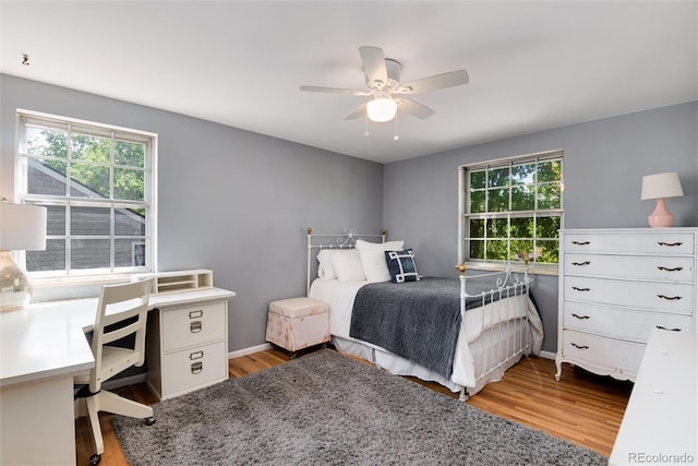 6624 S Sycamore St, Littleton, CO 80120 - bedroom featuring light wood-type flooring, multiple windows, a ceiling fan, and baseboards