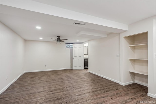 interior space with baseboards, visible vents, and dark wood-style flooring