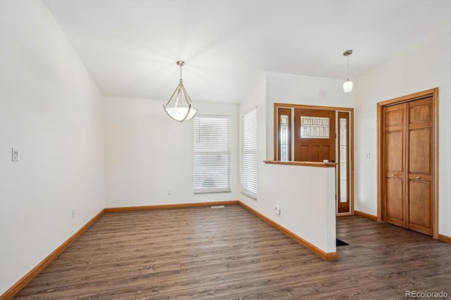 entrance foyer featuring wood finished floors and baseboards