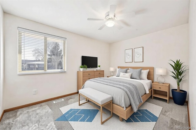 bedroom featuring carpet flooring, visible vents, ceiling fan, and baseboards