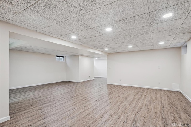 spare room featuring recessed lighting, wood finished floors, and baseboards