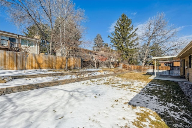 yard covered in snow featuring a fenced backyard and a patio