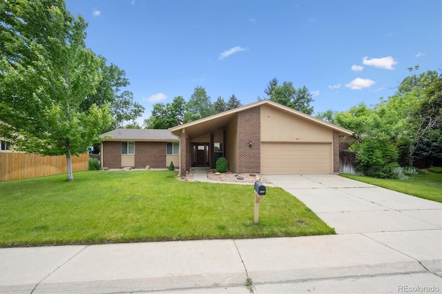 1843 S Pierson Ct, Lakewood, CO 80232 - view of front of property featuring an attached garage, brick siding, and driveway