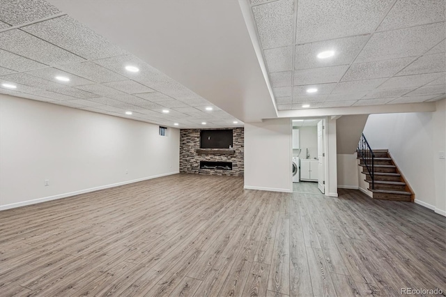 1843 S Pierson Ct, Lakewood, CO 80232 - unfurnished living room featuring wood finished floors, recessed lighting, a paneled ceiling, stairway, and washing machine and dryer