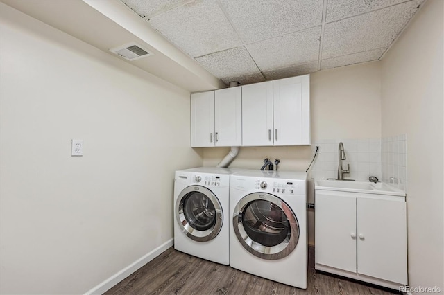 1843 S Pierson Ct, Lakewood, CO 80232 - washroom featuring cabinet space, separate washer and dryer, and wood finished floors