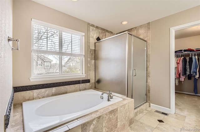 bathroom featuring visible vents, a garden tub, recessed lighting, a spacious closet, and a shower stall