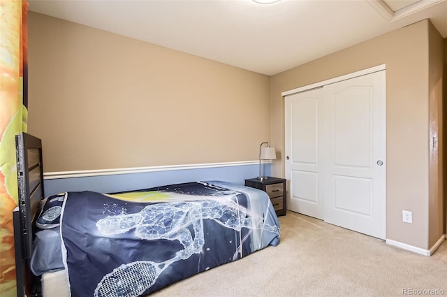 bedroom with a closet, carpet, and baseboards