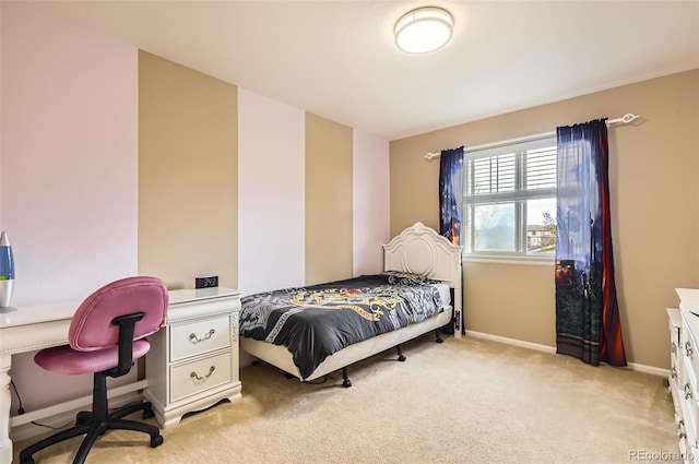 bedroom featuring baseboards and light carpet
