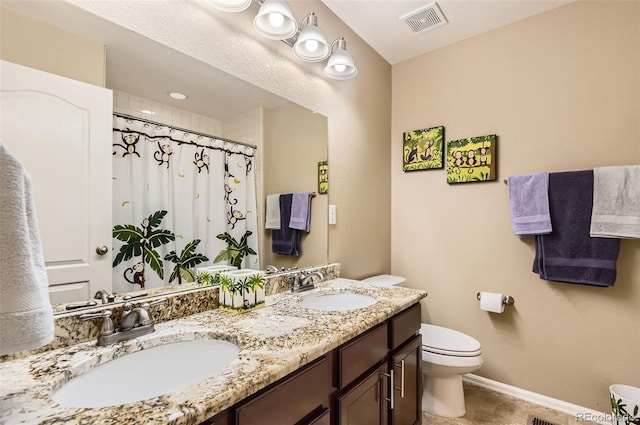 bathroom with toilet, baseboards, visible vents, and a sink