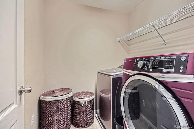 clothes washing area with laundry area and washer and dryer