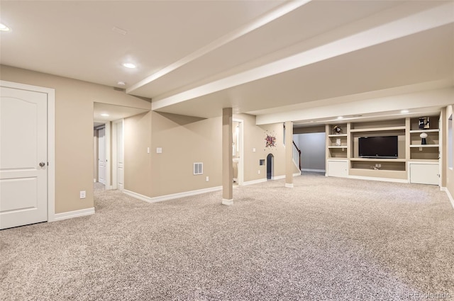 finished below grade area with visible vents, stairway, carpet floors, baseboards, and recessed lighting
