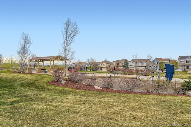 view of play area with a lawn, a gazebo, and a residential view