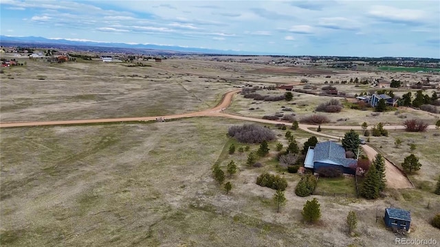 drone / aerial view featuring a desert view and a rural view