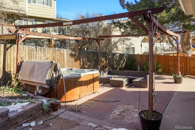 view of patio with outdoor lounge area and a hot tub