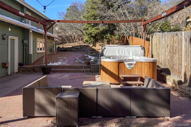 view of patio with an outdoor living space and a hot tub