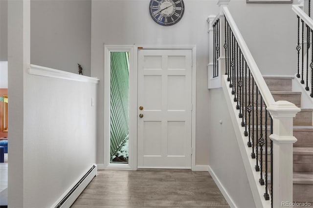 entrance foyer featuring hardwood / wood-style floors and baseboard heating