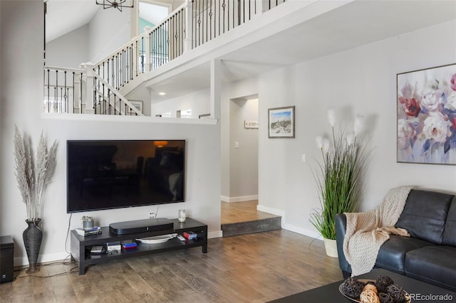 living room with hardwood / wood-style flooring and high vaulted ceiling