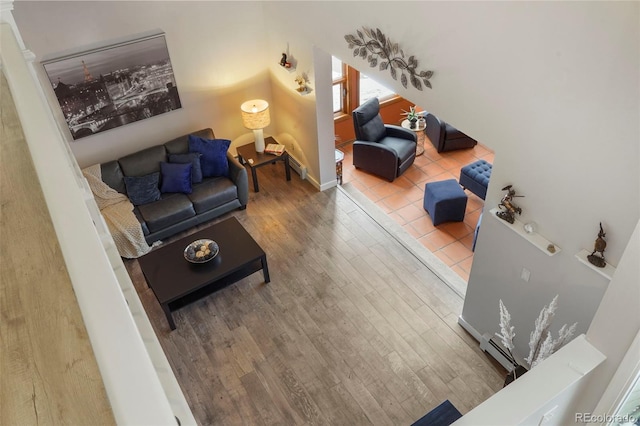 living room featuring baseboard heating and hardwood / wood-style floors