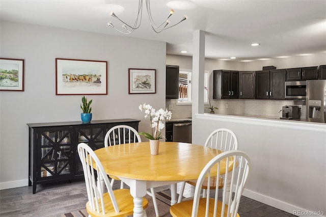 dining area featuring dark hardwood / wood-style flooring and a chandelier