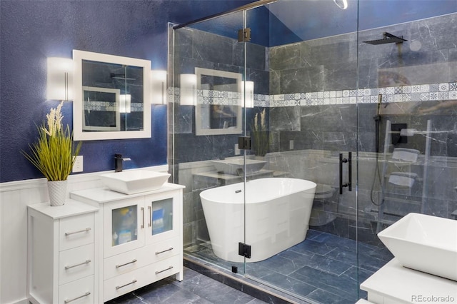 bathroom featuring shower with separate bathtub and vanity