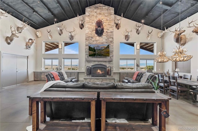 living room featuring a wealth of natural light, concrete flooring, and high vaulted ceiling