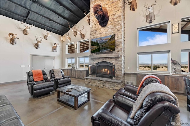 living room with a stone fireplace and high vaulted ceiling