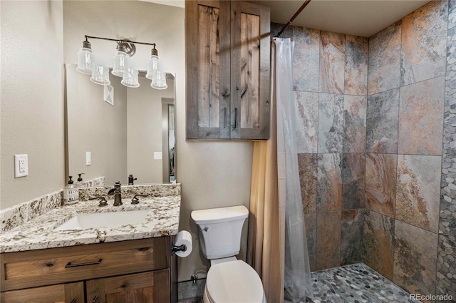 bathroom with vanity, toilet, and walk in shower